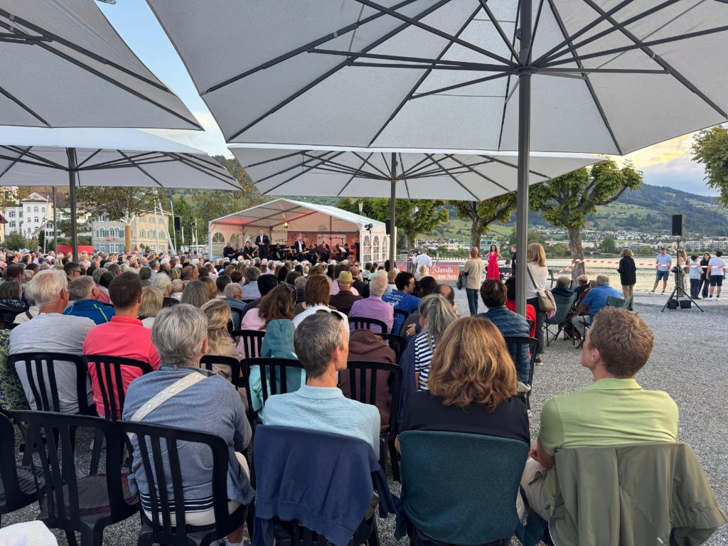Konzertblick mit Banner «Klassik am See» und Publikum am See